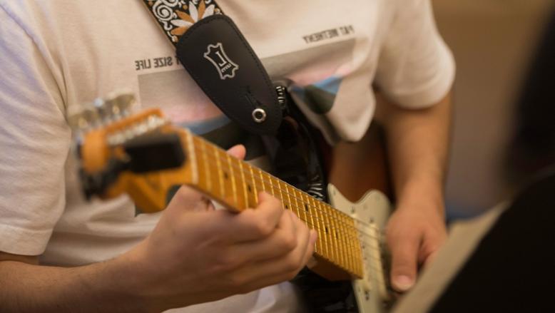 Guitarists practice in between Guitar Ensemble rehearsals