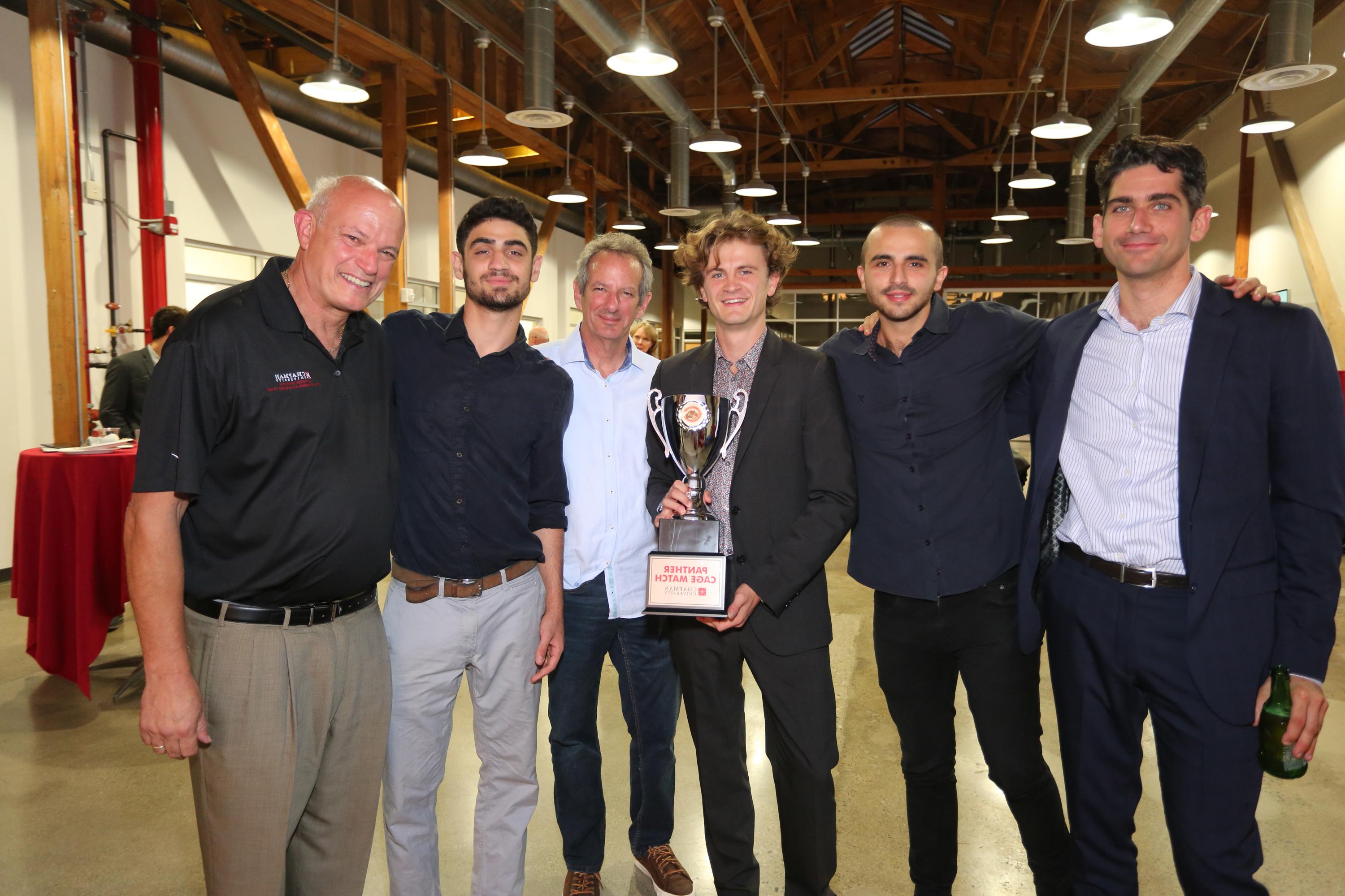 Members of Rugtomize with championship cup